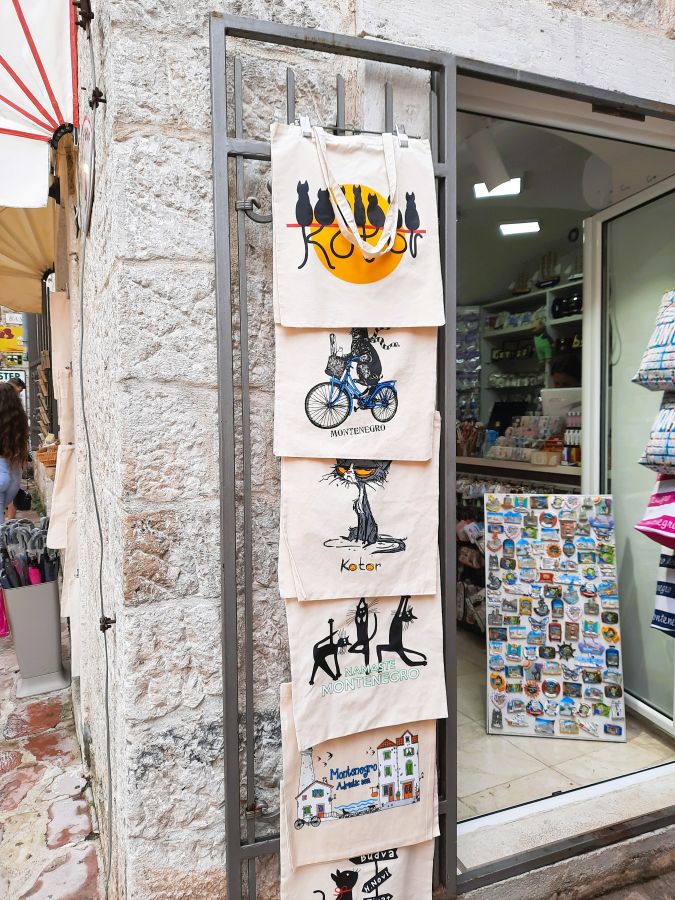 Souvenirtaschen mit Katzenmotiven vor einem Laden in Kotor, der Stadt der Katzen